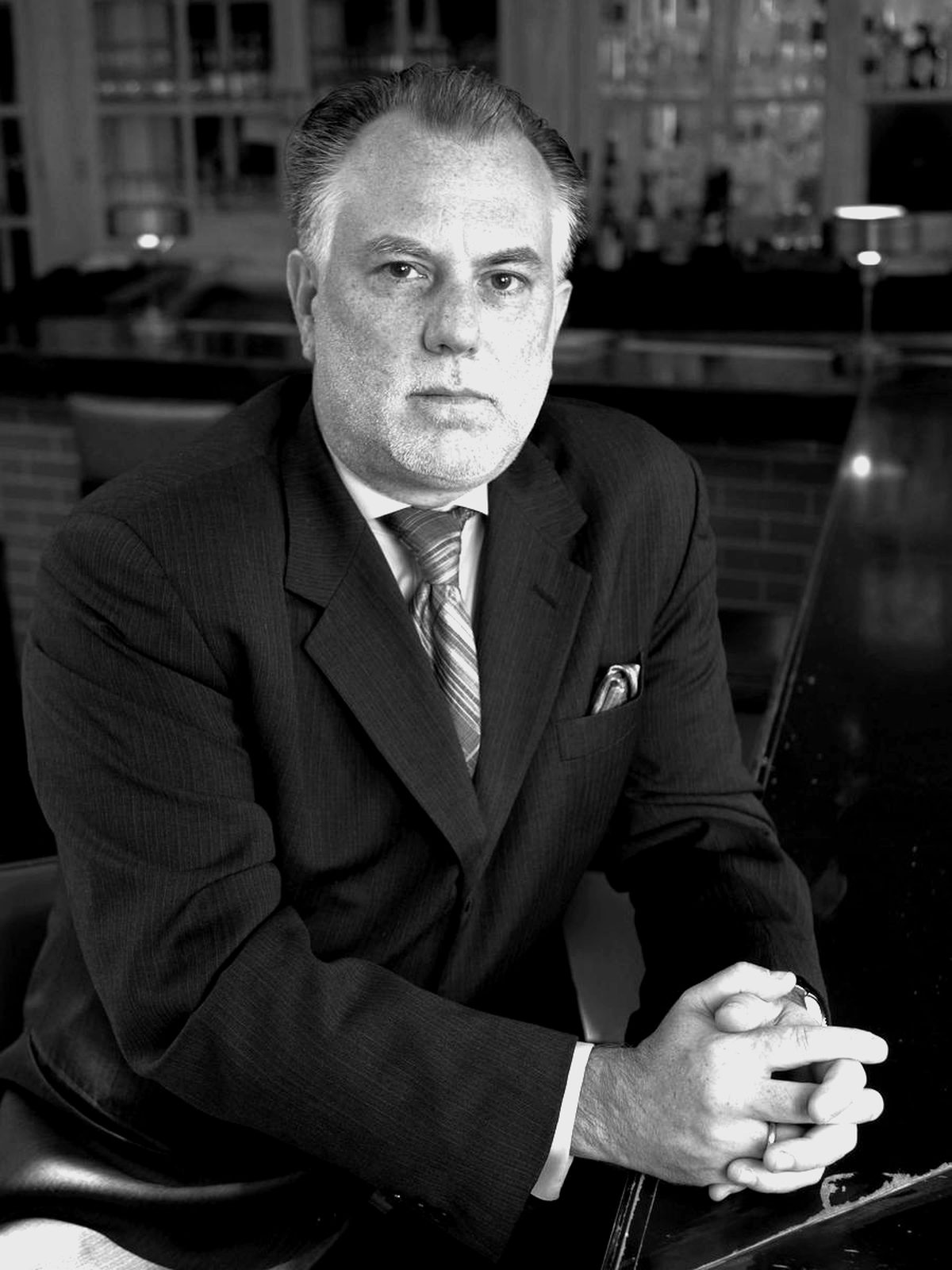 Harry Hayman seated at a bar, portrait